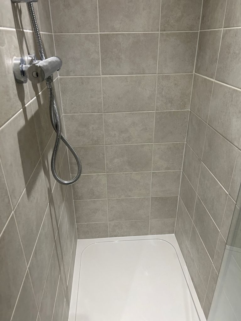 Grey-tiled walk-in shower fitted by Yorkshire Green Heating in Doncaster